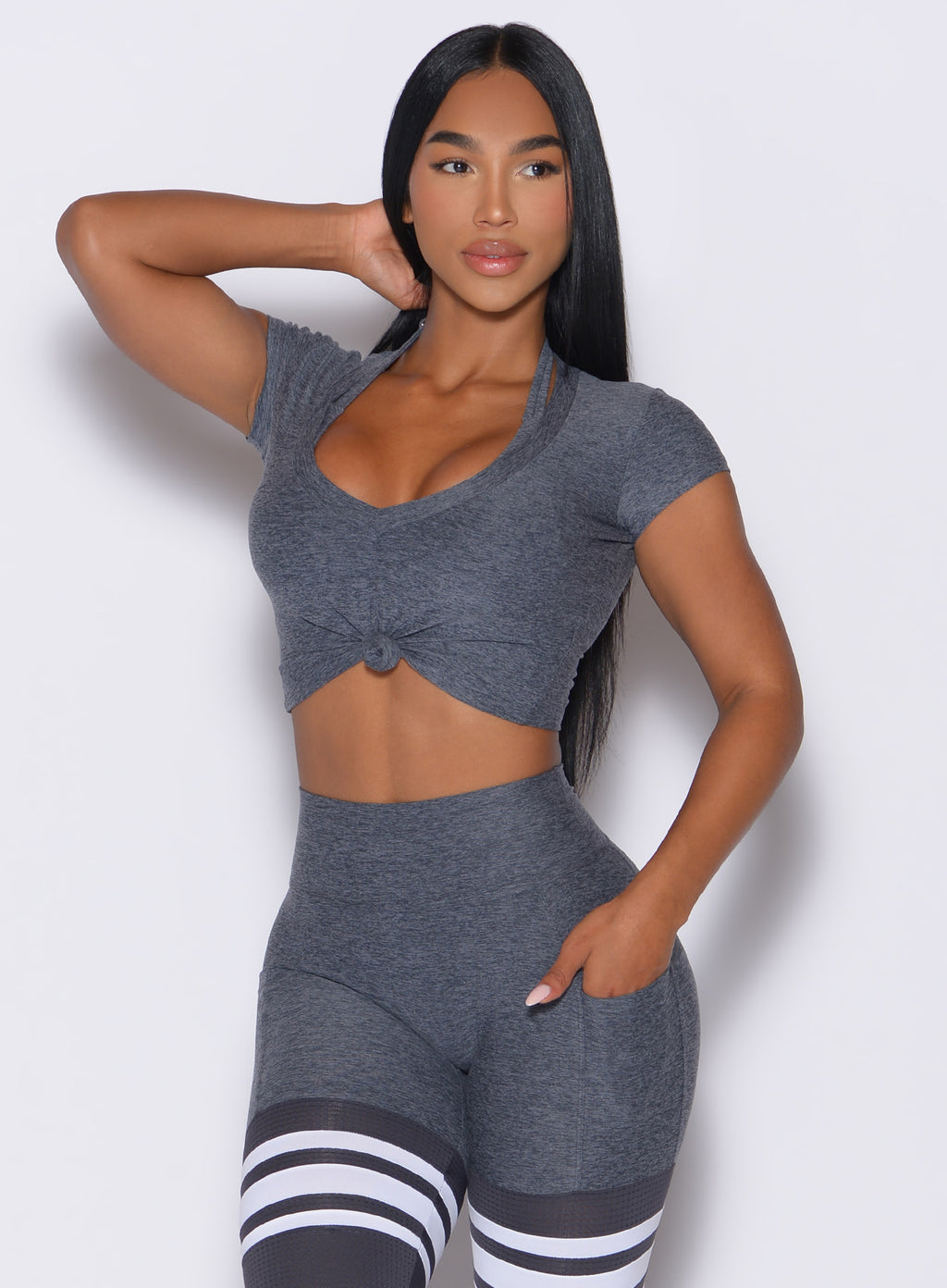 front view of model  wearing a gray activewear leggings and gray tshirt