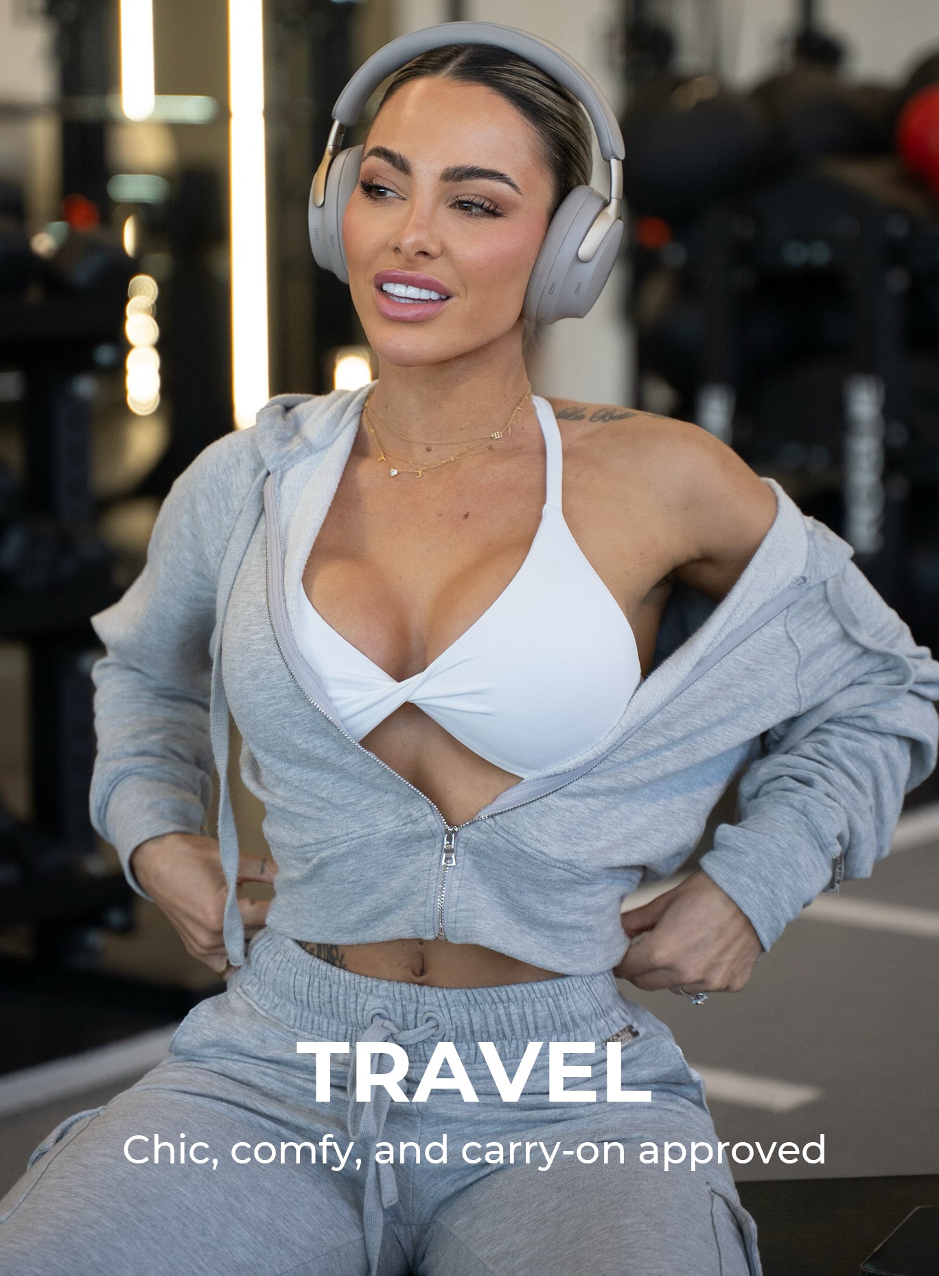 Model sitting inside a gym wearing the Cuddle Up Joggers in Cozy Silver paired with the matching jacket